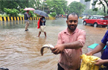 Man ’fishes’ out on flooded Mumbai street
